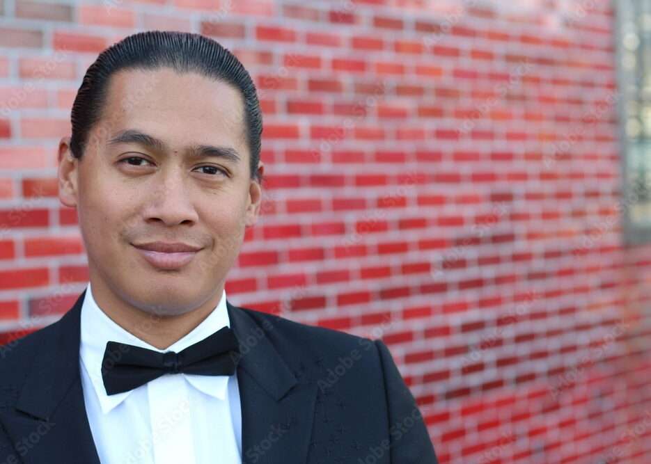 How to Choose the Perfect Black Wedding Tuxedo for Your Style Handsome young Asian man in a tuxedo looking at the camera. Fashionable Clothing. Clothing for the festive evening. Copy space on the right.