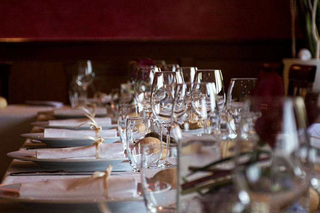 a-table-set-for-a-wedding-dinner-stockpack-unsplash | WEDISTRY BLOG rehearsal dinner cost