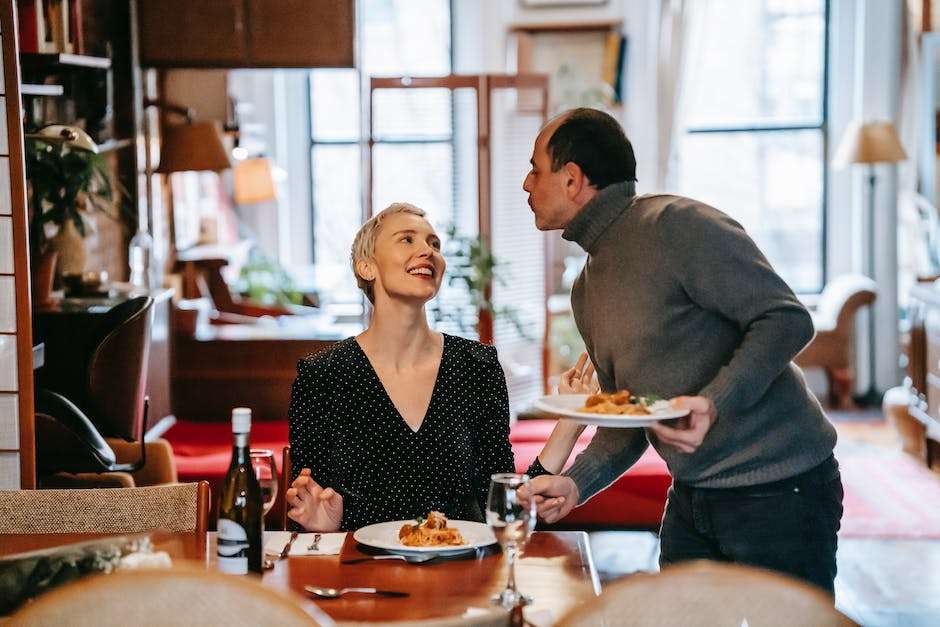 Image of a couple enjoying a romantic dinner in Savannah, with the city lights in the background.